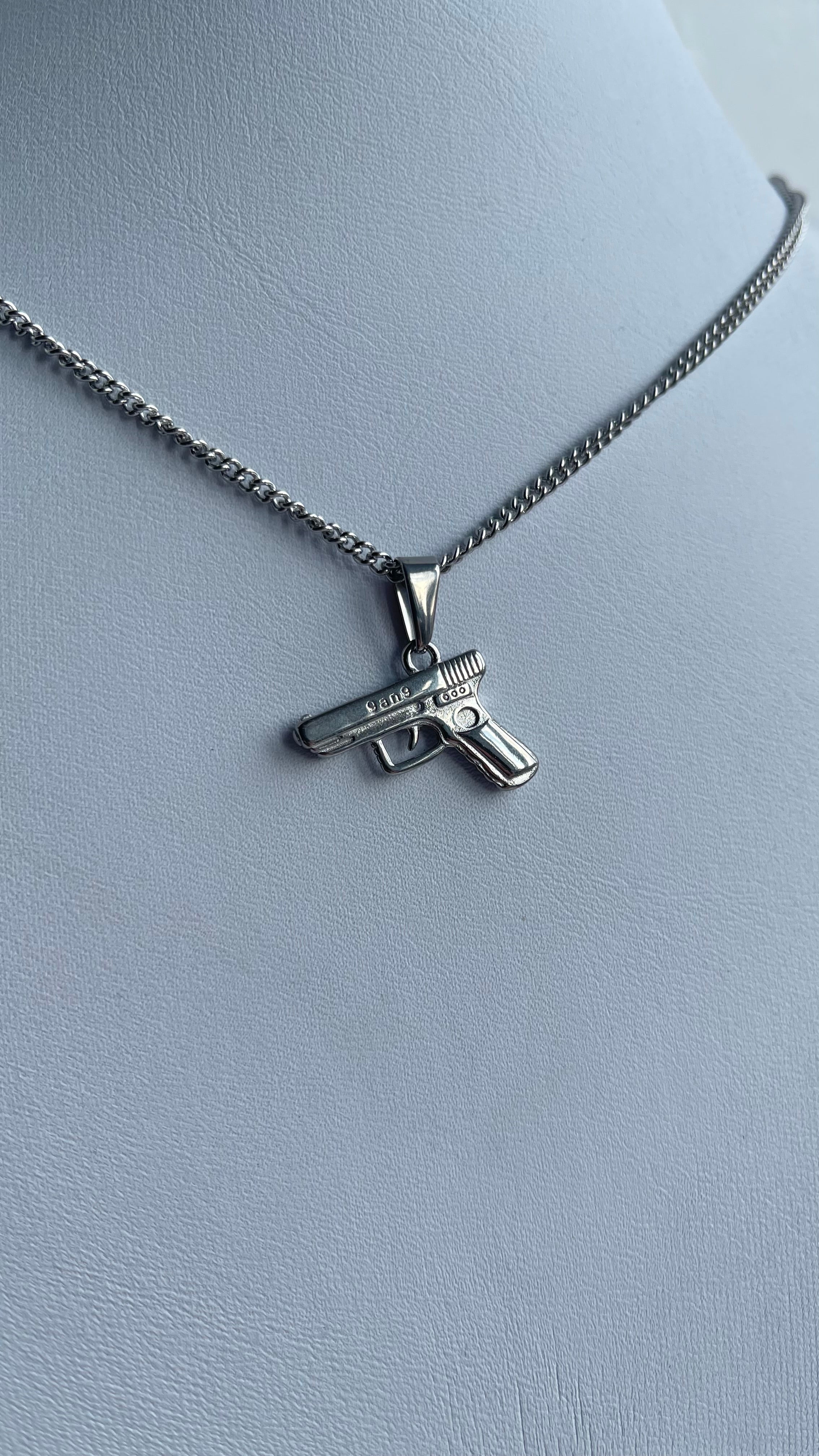 Pistol pendant on rounded box chain